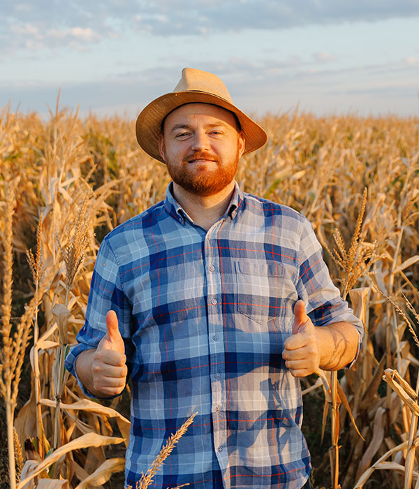 young farmer in hat smiling and showing thumb up s WXURME7